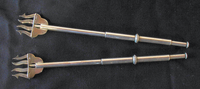 Two protractible silver lyre-shaped pickle forks
